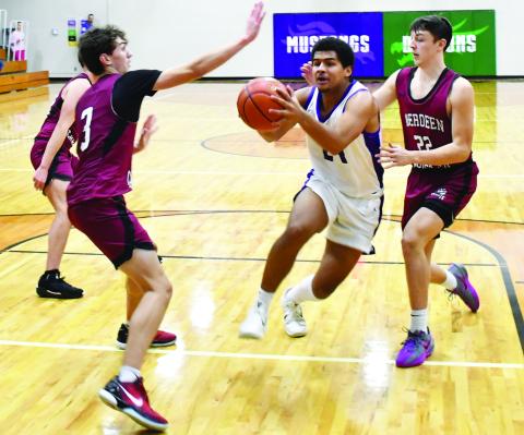 Waubay-Summit hosted Aberdeen Christian Knights Jan. 23 in a contest the Mustangs won 43-41. Here, Traveion Neilan (24) drives to the basket through Aberdeen Christian defenders Luke Kaiser (3) and Grady Jett (22). Reporter &amp; Farmer | Brenner Cariveau