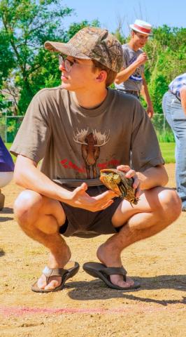 Andrew Pitzl of Eden waits for the start of his turtle racing heat during Eden Days festival June 28. Pitzl’s turtle dubbed Speedy couldn’t live up to its name and didn’t make the final round. Reporter &amp; Farmer | Leyton Beardslee