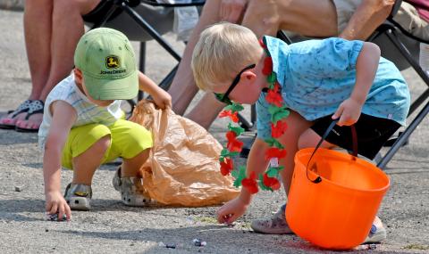 Kash Hoven, two, and Hayes Spiering, five, scramble to collect as much candy as they can during the Waubay Fun Fest parade July 20. Hoven is the son of Josh and Lauren Hoven of Webster, while Spiering is the son of Chris and Sarah Spiering, Webster. Reporter &amp; Farmer | Amanda Dulitz