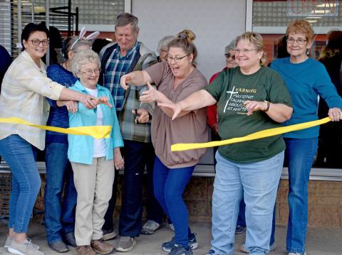 Melanie Gaikowski, Charlene Schlotte, Carol Richardt, Howard Hvidsten, Elaine Bistodeau, Needs Anonymous Director Kari Nelson, Mary Lindquist, Cathy Witzke and Anita Reiprich were among the volunteers on hand for a ribbon cutting ceremony April 12 during the Needs Anonymous grand re-opening event. See more, page 15. Reporter &amp; Farmer | Amanda Dulitz