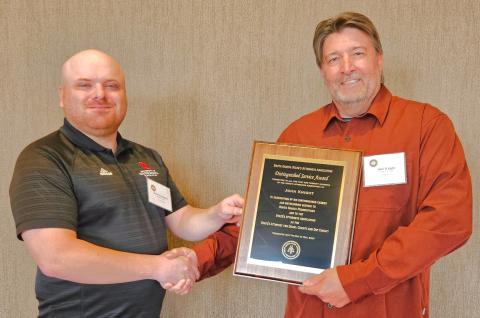 Roberts County State’s Attorney and Webster Area High School graduate Dylan Kirchmeier, left, awards Day County State’s Attorney John Knight, right, with the South Dakota State’s Attorneys Association 2025 Distinguished Reporter &amp; Farmer | subscriber snapshot Service Award.