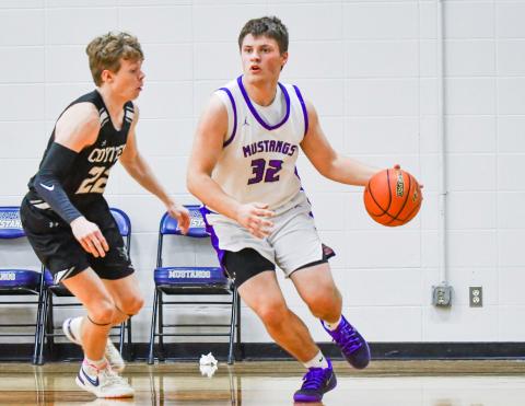 Tripp Gaikowski (32) of Waubay/Summit drives past a defender during the Mustang’s 66-49 win over Waverly-South Shore Coyotes Feb. 13 in Waubay. Gaikowski aided his team with four points in the victory. Reporter &amp; Farmer | Leyton Beardslee