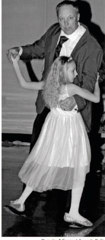 Corey Keintz allows his eight-year-old daughter Amelia to stand on his feet as the pair twirl around the dance floor March 28 at the Webster Area High School gym for the Once Upon a Dream Daughter Dance hosted by the Best Buddies Club. The event was a fundraiser for the newly organized student dub. Reporter &amp; Farmer | Amanda Dulitz