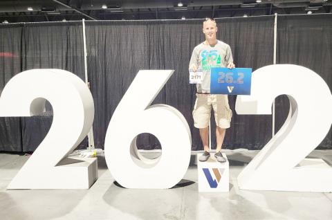 Waubay resident Curtis Huffman competed in the Las Vegas marathon Nov. 3 in Las Vegas, NV. Huffman said the conditions were extremely difficult at the start of the race with high winds and cold temperatures. Here, Huffman poses with his competition number in his right hand and a sign which displays the number of miles in a marathon while simultaneously standing on a larger display with the same figure. Reporter &amp; Farmer | Subscriber Snapshot