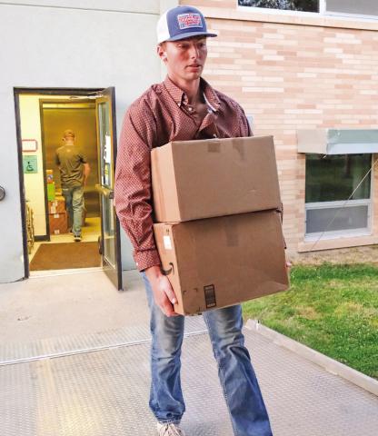 Gage Wik, along with other youth from Christ the King Catholic Church, helps load artifacts from the Day County Courthouse Museum into a trailer Oct. 1. The entire courthouse museum will be transported to the Museum of Wildlife, Science &amp; Industry which has built an additional building to house the combination of the two museums. Reporter &amp; Farmer | Leyton Beardslee
