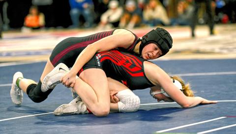 Macee McGregor of Webster Area attempts to pin Chole Caton of Yankton Gazelles during their match in the SDHSAA Girls State Championships Feb. 27 in Sioux Falls. McGregor won the match 11-3 by major decision but did not place for the 115 weight class after being eliminated in the following round. Reporter &amp; Farmer | Brianna Jorgenson, Captured Creations Photography