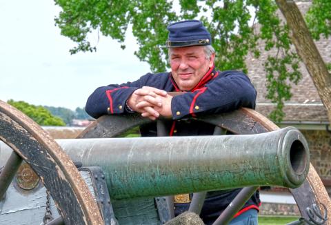 Dave Peterson leans against the wheel of a cannon during Fort Sisseton Historical Festival at Fort Sisseton State Park June 7. According to Peterson he has participated in reenactments and historical festivals for 34 years since 1991. Reporter &amp; Farmer | Leyton Beardslee