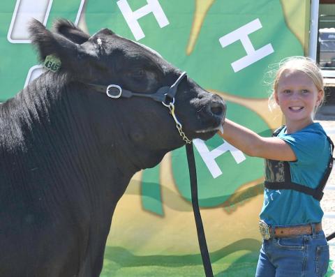 Posing with her reserve grand champion market beef is Kori Gaikowski during the Day County Fair Aug. 9. Reporter &amp; Farmer | Amanda Dulitz