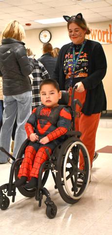 Webster Area first grade student Greyson Brave Bull and paraprofessional Kristen Marko take part in a Halloween costume parade Oct. 31 at Webster Area Elementary. Brave Bull is the son of Chris and Leta Brave Bull. Reporter &amp; Farmer | Leyton Beardslee