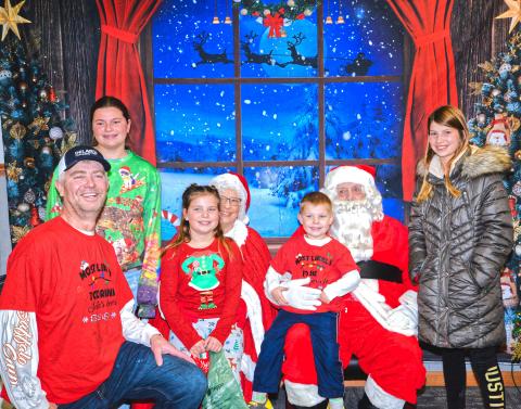 Santa and Mrs. Claus greet and take pictures with families at Waubay Senior Center Christmas celebration Dec. 6. From left, Dave, Aliyah, Abigail, Trenton and Kallie Zirbel get asked by Santa and Mrs. Claus if they’ve been good this year and what type of gifts they want for Christmas. Reporter &amp; Farmer | Connor Handrahan