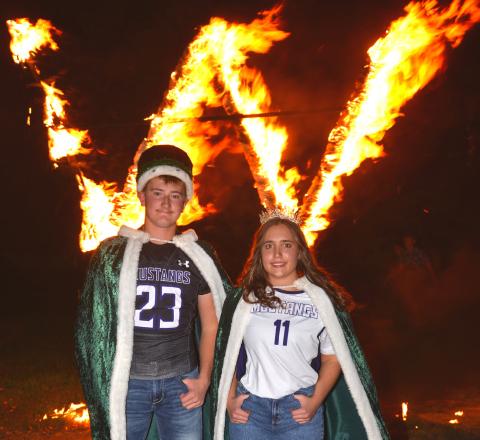 Waubay Homecoming King Witten Butler, left, and Queen Bailey Utne, right, at the homecoming ceremony Sept. 28, just moments after lighting the W. Reporter &amp; Farmer | Timothy Gibson