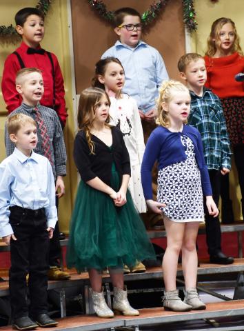 Located at the Webster Armory Dec. 9 k-6 students performed a variety of musical acts in the winter concert including a band and choirs. Here, second grade students from left in back, Archer Chevalier, Rhiley Zimmerman, Harlyn Deutsch along with middle row from left, Colten Hodge, Reagan Thompson, Lincoln Nimmer. From left in front row, Sawyer Zenk, Ava Schulz, Eva Garrett stand and sing holiday songs. Reporter &amp; Farmer | Brenner Cariveau