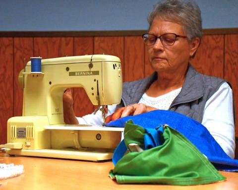 (Above) Sewing with a Purpose is a new group that helps create hygiene bags for young girls in South Africa. Journey of Faith is helping make this project possible and many church members have come to help with it. Here, Judy Williams starts sewing part of a bag’s exterior. Reporter &amp; Farmer | Connor Handrahan