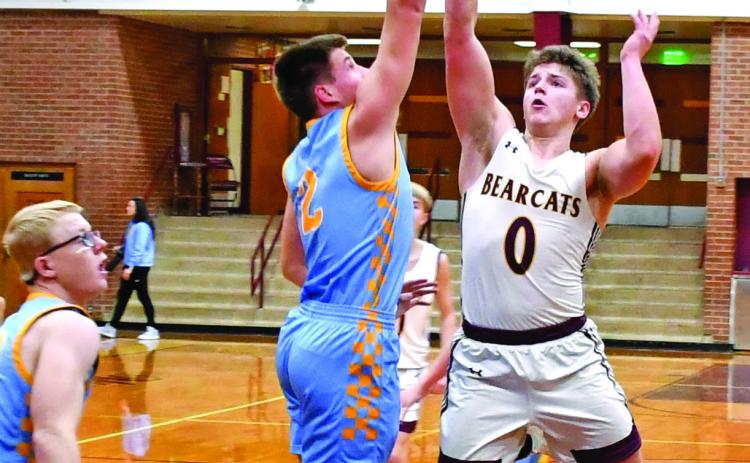 Webster Area Bearcats hosted the Hamlin Chargers Jan. 16 in a contest the Bearcats lost 22-71. Here, Tate Mammenga (0) attempts a floater over a pair of Hamlin defenders. Reporter &amp; Farmer | Robert Dulitz
