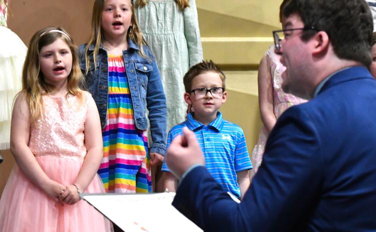 First graders Thea Sigdestad, Harlow Heupel and Leo Siemonsma perform during Webster Area School’s elementary spring concert April 24.