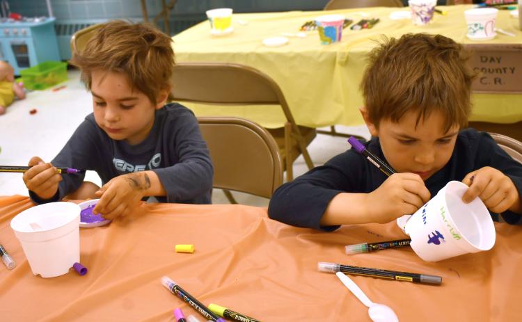 Reporter &am Farmer | Annie Witt Brothers Jefferson and Harrison Fosheim decorate plant pots at the Mornings with Moms event which took place June 4 at the Day County Courthouse community room. Mornings with Moms is a group for parents and guardians of young children which facilitates meet-ups activities together. The group has a partnership with the Webster Public Library.