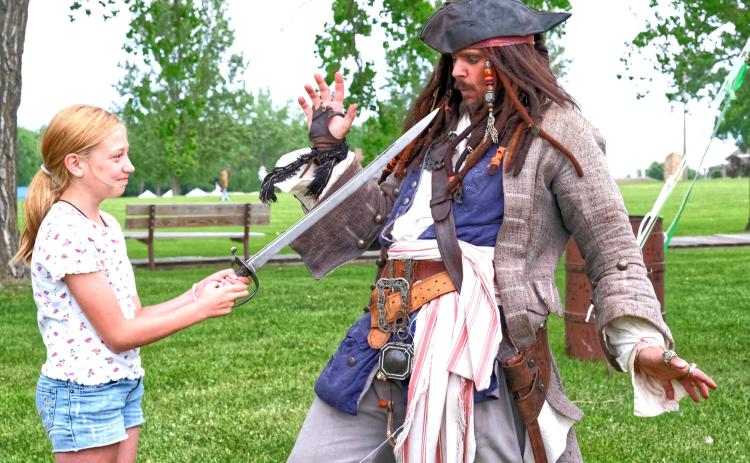 From left, Eva Schuelke pointed a sword at Joshua Godfredson portraying Jack Sparrow June 7 during Fort Sisseton Historical Festival at Fort Sisseton State Park. Godfredson gave a performance educating attendees on the history of pirates. Reporter &amp; Farmer | Leyton Beardslee