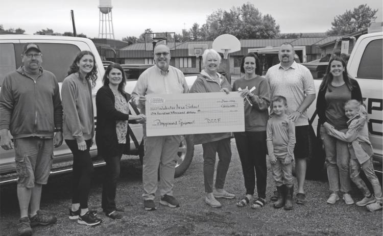 Day County Community Foundation donated $100,000 to Webster Area School's playground equipment project. Pictured from left are Mike Ninke, Emily Wagner, Allegra Duerre, Todd Garry, Rita Johnson. Alyssa and Huck Shoemaker, Craig Case and Natalie and Lucy Kuecker. Reporter &amp; Farmer | Annie Witt