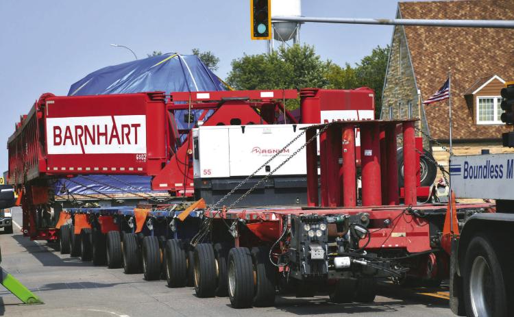 A steam turbine hauled on a trailer by three semi-trucks is pulled down Main St. in Webster Sept. 8. South Dakota Department of Public Safety was unable to release details about the turbine’s exact destination or owner but a pilot vehicle driver confirmed it was going to be heading north to Canada. The rig had an excess of 200 tires. Reporter &amp; Farmer | Leyton Beardslee