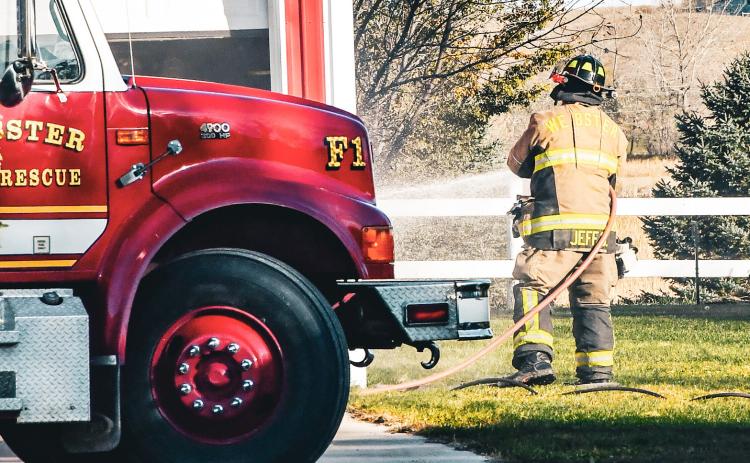 Jeff Smidt of Webster Fire Department hoses down the outside of a detached garage at 14074 SD Hwy. 12 near Webster after an electrical fire broke out Oct. 23. Assistant fire chief Eric Kwasniewski reported there was no one injured in the fire and no major structural damage was sustained to the building.