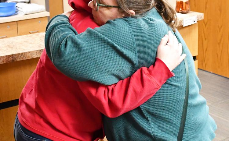 An anonymous citizen purchased a jacket at Ace Hardware Feb. 6 for Webster Area School crossing guard Annette Duarte after they saw her in the cold without the proper attire. Once the jacket was purchased, the good Samaritan asked Ace Hardware owner Shannon Garduno to drop the jacket off at the school for Duarte. Here, Garduno embraces Duarte after the jacket was presented. See more on page 6. Reporter &amp; Farmer | Brenner Cariveau
