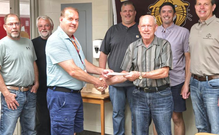 Webster Kiwanis donates $10,000 to the Webster Area School District. According to Kiwanis member Ken Roerig, this is the third of five donations Kiwansis pledged to make towards the school. Accepting the donation are Webster Area School board members from left, Aaron Gaikowski, Mark Hanson, Superintendent Jim Block, Joel Shoemaker, Roerig, Nick Fosheim and Tom Sannes. Reporter &amp; Farmer | Connor Handrahan