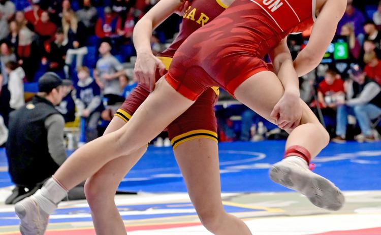 Macee McGregor picks up Sisseton Redmen wrestler Clara Iverson during the Lee Wolf tournament Feb. 1, winning via decision for a fifth place finish in the 120 pound girls division. Reporter &amp; Farmer | Subscriber snapshot