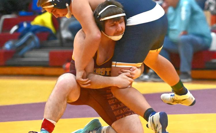 Matthew Angiolelli of Webster Area Bearcats lifts his opponent during the Webster Holiday Tournament Jan. 3 at Webster Armory. Angiolelli placed third in the 215 weight class with a record of 3-1. Reporter &amp; Farmer | Brianna Jorgenson, Captured Creations Photography