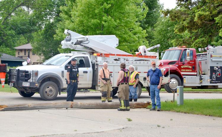 At the scene of where a service truck hooked an overhead cable causing a number of power lines and poles to go down in Webster June 7 stands Webster Police Chief Craig Baumgarn and Webster Volunteer firefighters Fritz Kwasniewski, Eric Kwasniewski, Wes Hoven and Austin Eisenbraun. Reporter &amp; Farmer | Annie Witt