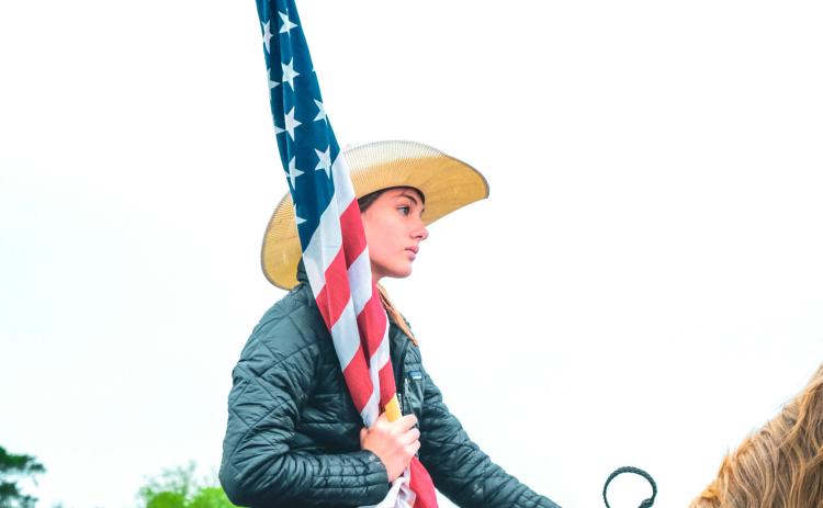Bri White prepared for a performance of “The Star-Spangled Banner” ahead of the Waubay Roundup rodeo June 14. The first year for the annual rodeo went on despite rain earlier in the day which caused muddy arena conditions. Reporter &amp; Farmer | Leyton Beardslee