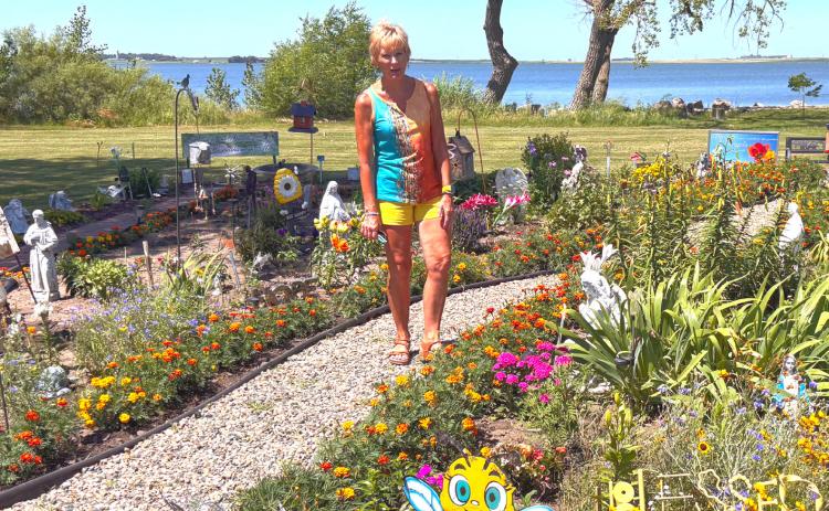 The Angel Memorial Garden comes to life each spring along the shore of Blue Dog Lake, where Waubay community members led by Brenda Holscher, pictured center, plant flowers and perennials to remember loved ones. Reporter &amp; Farmer | Timothy Gibson