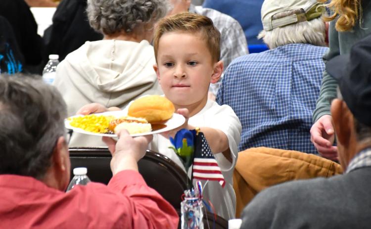 Jackson Meyer helps serve a meal during the veterans banquet at Webster Armory Nov. 8. Meyer is the son of Calvin and Bailey Meyer of Webster. Reporter &amp; Farmer | Leyton Beardslee