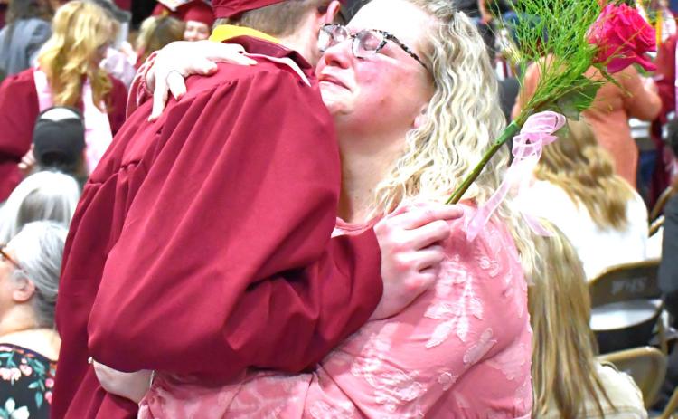 Webster Area High School held their graduation May 17 at Webster Armory. The stands and floor were packed with supporting friends and family. Angela Ayres hugs her graduate, Lukas Johnson, after he gives her a graduation flower. Reporter &amp; Farmer | Connor Handrahan