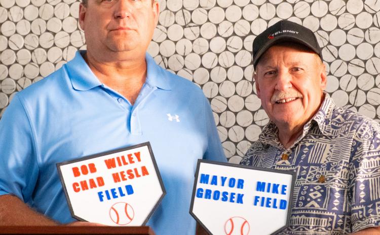 Baseball complex coordinator and Webster Legion baseball coach Chad Hesla and Webster Mayor Mike Grosek received plaques Aug. 16 for baseball fields which will be named after them at Veteran’s Memorial Sports Complex in Webster. Hesla has been coaching baseball for 25 years and spent significant time fundraising and planning for the complex. Grosek coached for 20 years starting at age 17 and was mayor when the city purchased the land for the site in 2000. Reporter &amp; Farmer | Leyton Beardslee