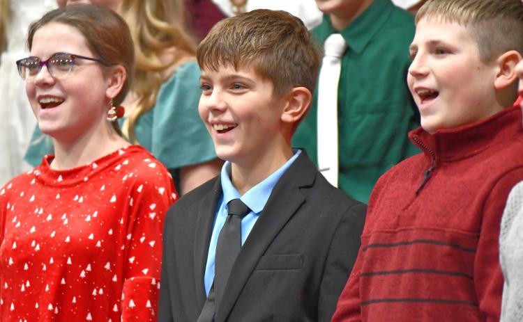 Webster Area seventh graders, from left, Cheyenne Powell, Ian Mammenga and Bryson Bloom perform in the school’s winter concert Dec. 6 at Webster Armory. The event featured choral and band performances from middle and high school students. Reporter &amp; Farmer | Leyton Beardslee