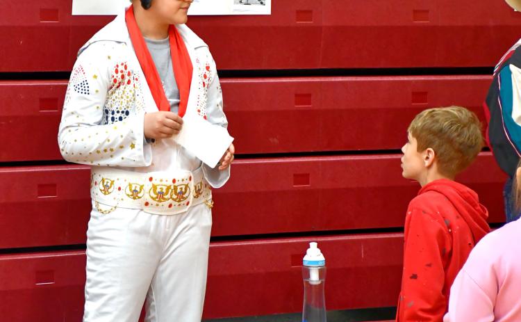 Grant Hauck gives his best Elvis impression as part of a wax museum event by Webster Area Elementary students at the Webster Armory May 2. Students dressed up as historical figures and gave presentations on their significance to those who attended. Reporter &amp; Farmer | Leyton Beardslee