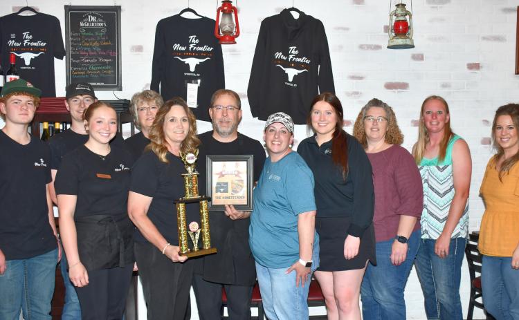 The New Frontier restaurant received their award from Webster Area Chamber of Commerce for winning the 2025 burger battle competition with their burger “The Homesteader.” In the restaurant June 10 are from left, New Frontier employees Delaney Atherton, Caleb Gaikowski, Brylie Reeves, Sharil Guthmiller, restaurant owners Kristi and Aaron Gaikowski and chamber members Alisha LaCourse, Kayla Fischer, Amy Fischer, Kelly Brandlee and Bailey Meyer. Reporter &amp; Farmer | Leyton Beardslee