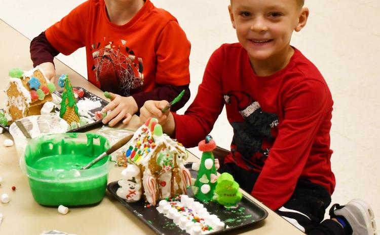 Missy Hortness’ first grade class spent time making gingerbread houses Dec. 12. Here from left, Camdyn Huffman and Lawson VanderLinden sit next to their gingerbread houses. Reporter &amp; Farmer | Brenner Cariveau