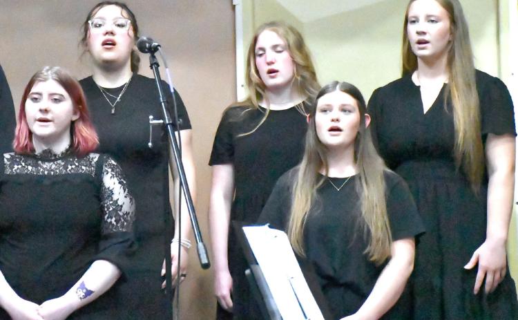 From back row left, Izzy Ladue, Rylan Huggett, Callie Shoemaker; from front row left, Shantel Holzerland and Tenley Spiering join other students in singing during the Webster Area music concert May 4. Reporter &amp; Farmer | Connor Handrahan