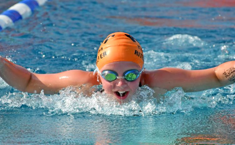 Webster Tigerfish Hadley Rithmiller throws her arms forward to propel herself through the water July 9 during the Webster 12 and Under Fun Meet. Reporter &amp; Farmer | Amanda Dulitz