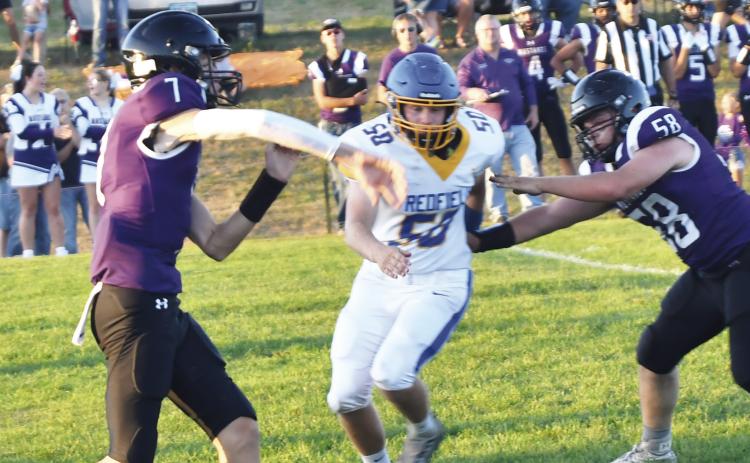 Sophomore Evan Aker (7) throws the ball against the Redfield Pheasants during Waubay-Summit’s homecoming contest against the Pheasants Sept. 20. Blocking for Aker is Caleb Miller (58). The Mustangs defeated the Pheasants 38-0. Reporter &amp; Farmer | Brenner Cariveau