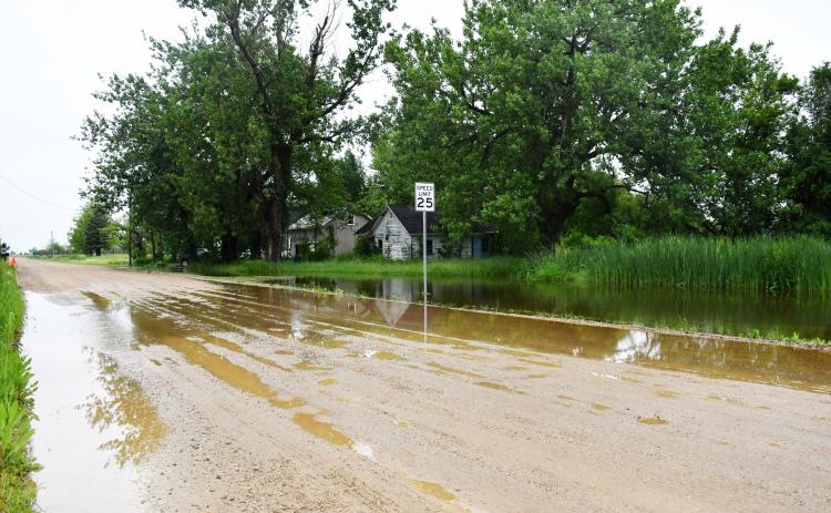 Heavy and consistent rain in the area has made many area gravel roads look like the one shown above, June 25 in Waubay near the crossing of Main Street and Jones Avenue shows rising water in the ditch flowing onto the road. Reporter &amp; Farmer | Annie Witt