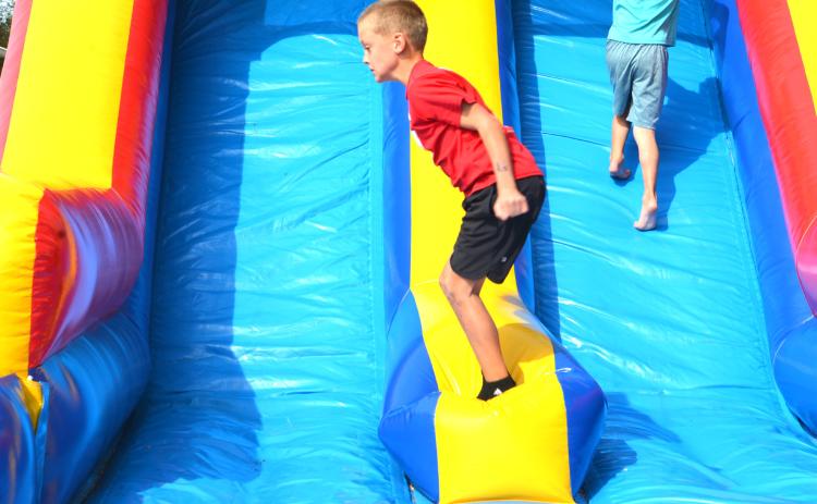 Many kids enjoyed the festivities held at Harvest Bash Sept 12. Lawson Vander Linden, age eight from Webster, hops from side to side on the inflatable side. Reporter &amp; Farmer | Connor Handrahan