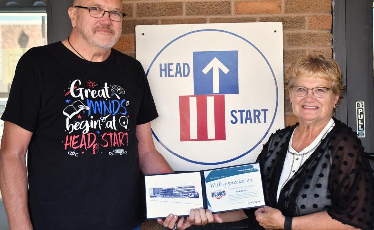 Rick Buhler, left, received the Modern Woodmen hometown hero award for his near 11 years of volunteering at the Webster NESD Head Start Center. The award was presented last week by Bernie Kurkowski, right. Buhler began volunteering at the child care non-profit in early 2015 after retiring. See full story on page 1. Reporter &amp; Farmer | Leyton Beardslee