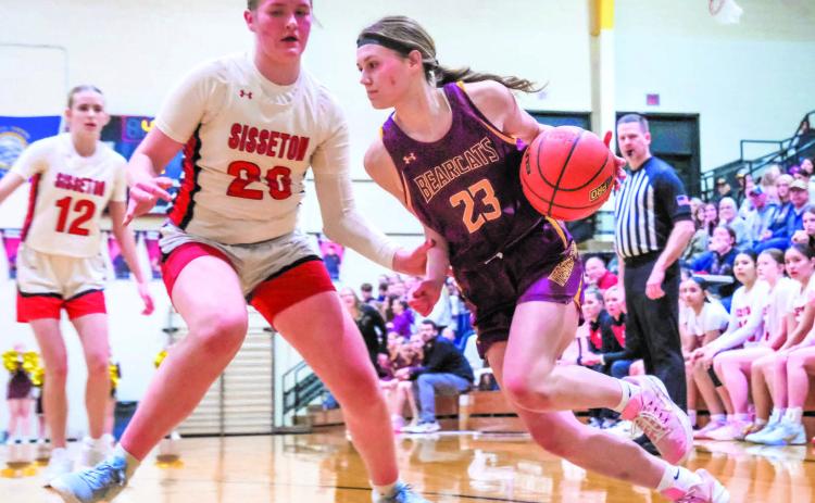 Cartney Hanson (23) of Webster Area drives past Piper Langager (20) of Sisseton Redmen during their playoff matchup Feb. 24 in Sisseton. Bearcats fell in the game with a final score of 35-70 ending their season. Reporter &amp; Farmer | Leyton Beardslee