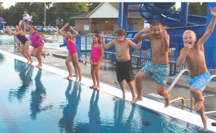 Dozens of local children dove in for one last swim on the last day of Webster pool’s 2026 season Aug. 13. From left to right: Karley Lone, Lydia Petersek, Brooklyn Bohnenkamp, Lyric Cyrus, Calliope Cyrus, Reagan Thompson, Dylan Ellis, Hunter Swenson and Tucker Franson. Seated in the background is lifeguard Josie Spiering. Reporter &amp; Farmer | Timothy Gibson
