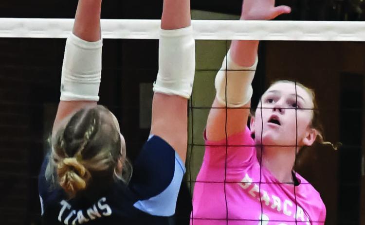 Karli Sannes (12) of Webster Area hits the ball over Kalyce Achen (3) of Leola/Frederick Area during the Bearcats 3-0 match win over the Titans Oct. 6 in Webster. Set scores for the match were 25-11, 25-21 and 25-16. Reporter &amp; Farmer | Amanda Dulitz