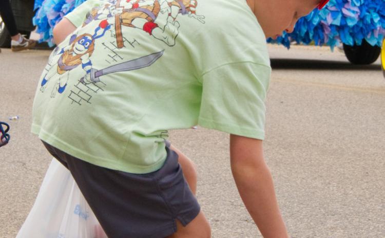 Barrett Cimburek of Mitchell picks up candy during the parade at Waubay Fun Fest July 19. The annual celebration draws hundreds of people every year to its festivities. Reporter & Farmer | Leyton Beardslee