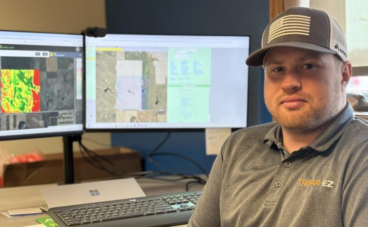 Cody Kafka sits at his work desk in Mitchell with his new land purchase displayed on his computer screen Sept. 4. Reporter &amp; Farmer | Joshua Haiar for South Dakota Searchlight