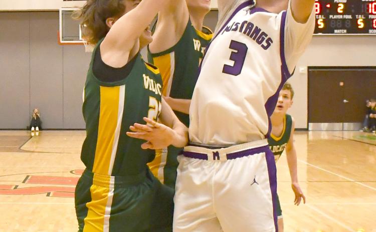 Mustangs boys faced Northwestern Wildcats March 7 in the first round match of the regional bracket. Waubay-Summit won the contest with a 51-43 score. Here, Hogan Hlavacek (3) attempts to shoot the ball amid a cluster of Northwestern defenders. Reporter &amp; Farmer | Brenner Cariveau